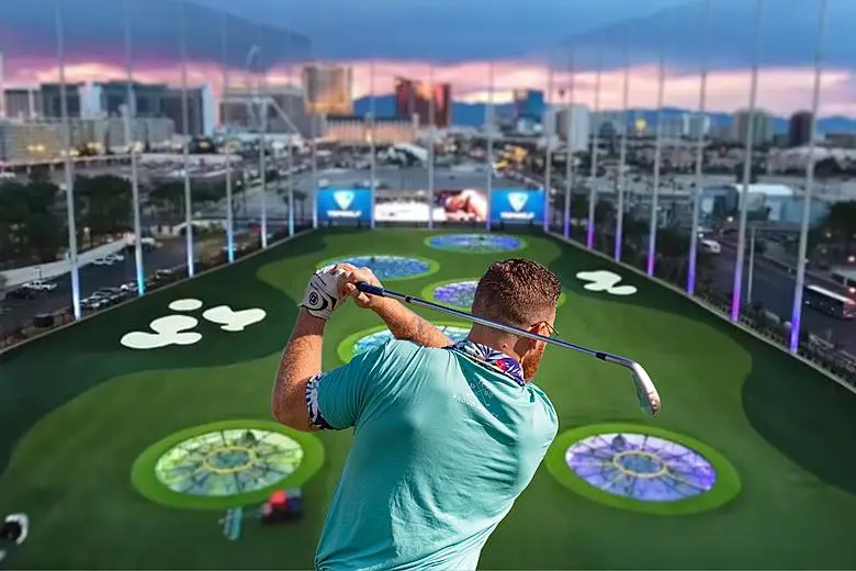 Golfer playing at a Topgolf driving range