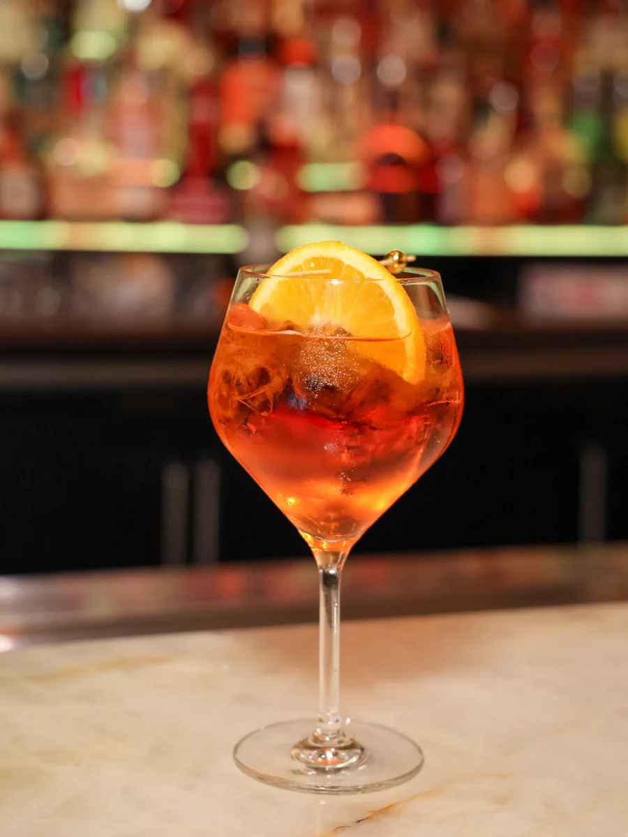 An orange-garnished cocktail at Magnificent Mile